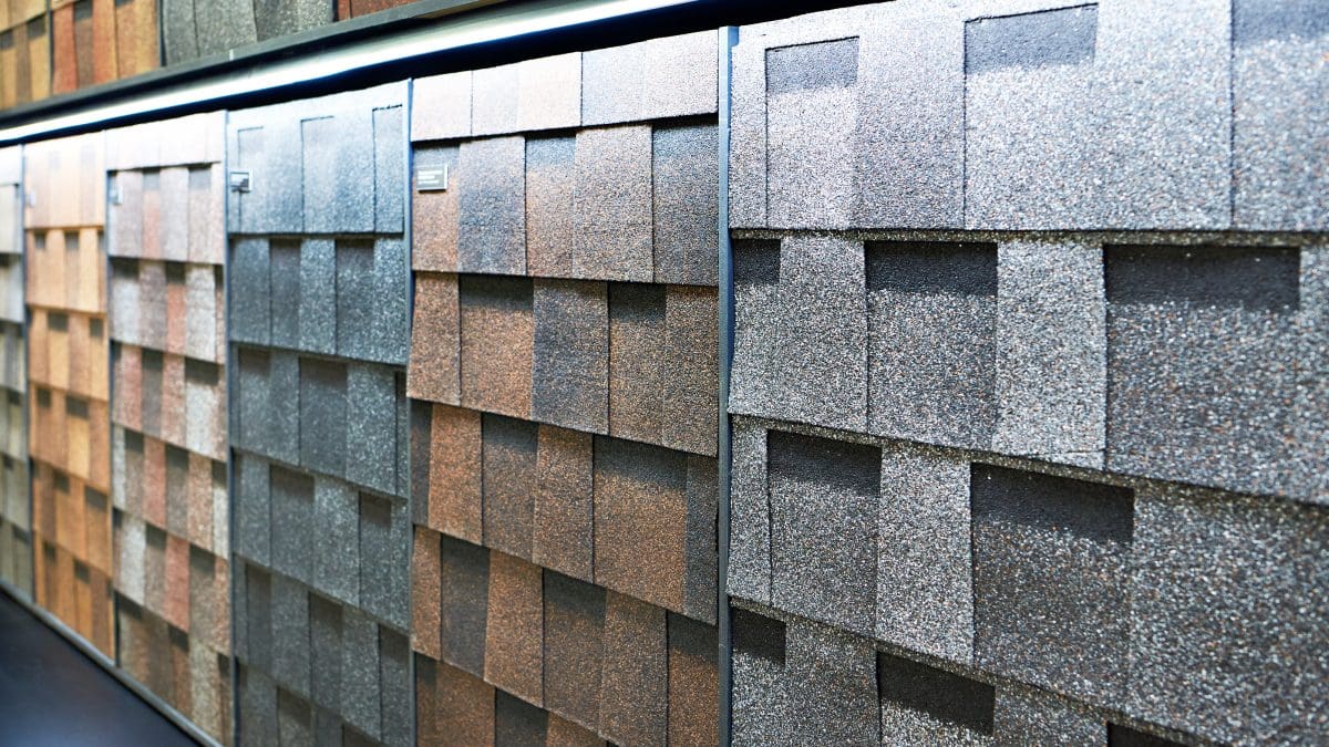 A store display of GAF designer shingles in a variety of brown, gray, and clay-colored shingles.