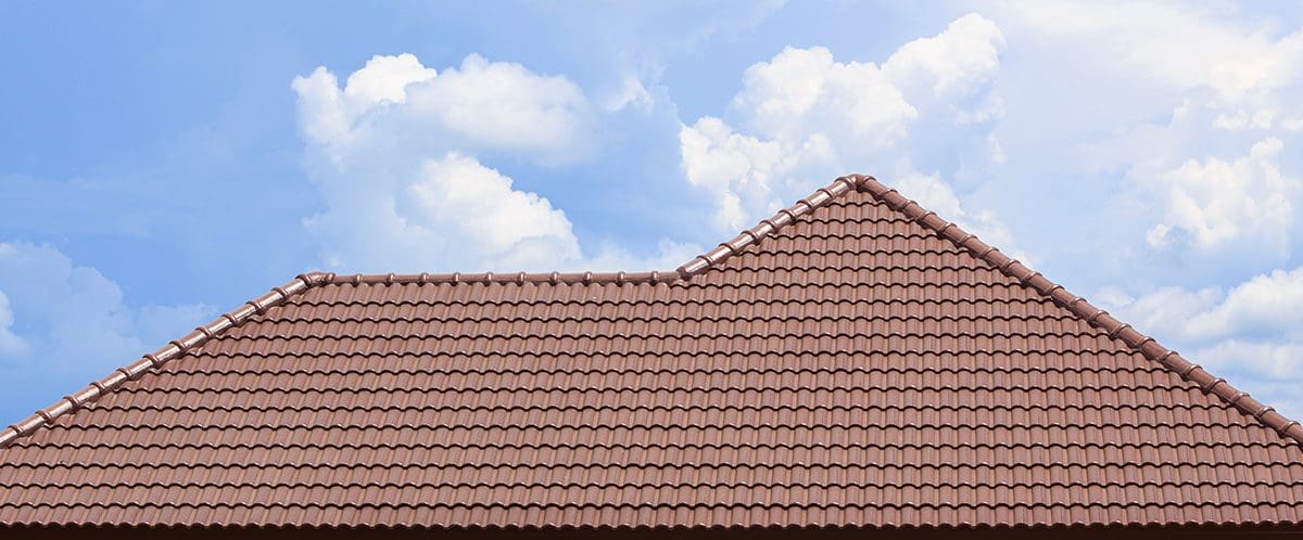 A clay tile roof with a blue sky backdrop