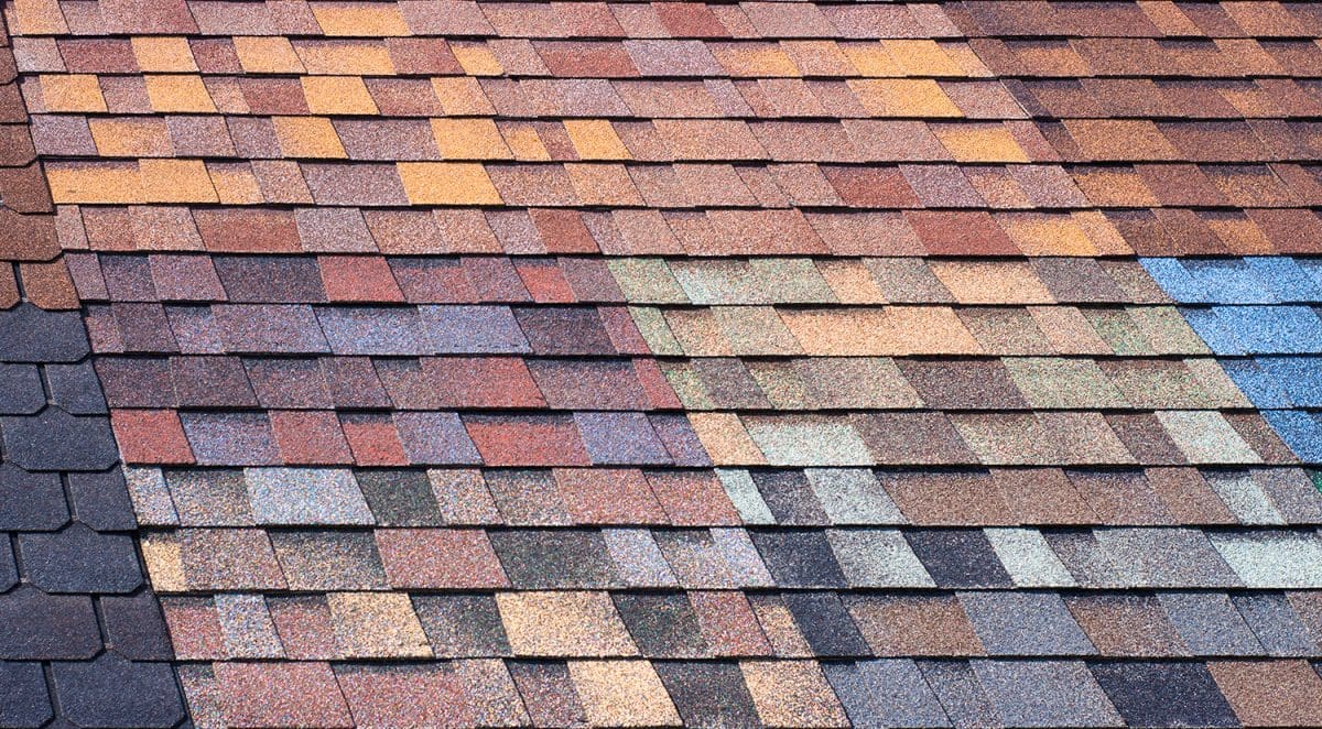 A roof with sections covered in different multicolored wings.