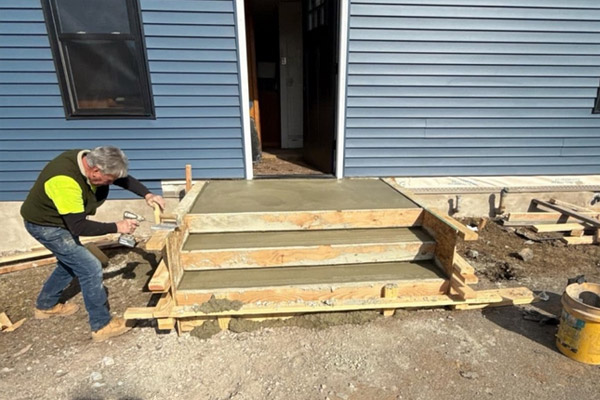 A Green Rhino Builders employee replacing a deck at a customer’s home