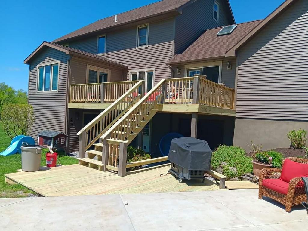 a deck with stairs on the side of a house