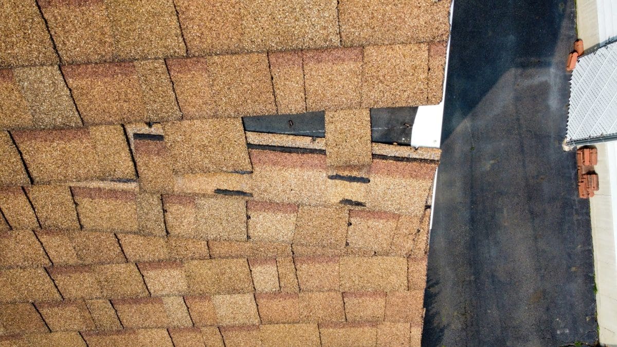 Close-up of damaged roof shingles needing residential roof replacement